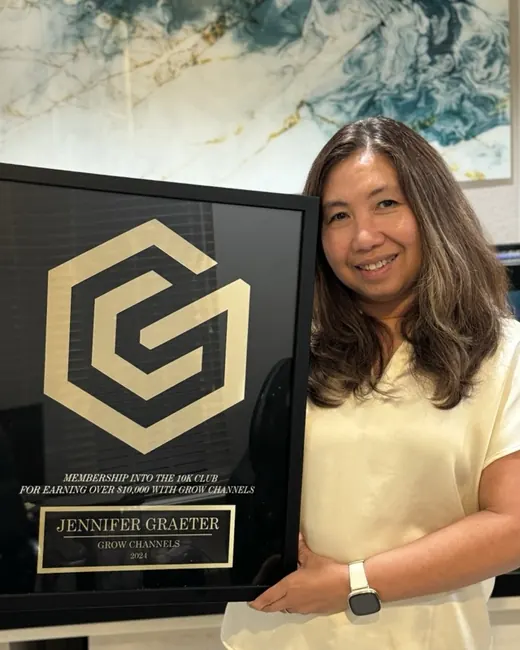 Jennifer Graeter holding their 10K Club plaque
