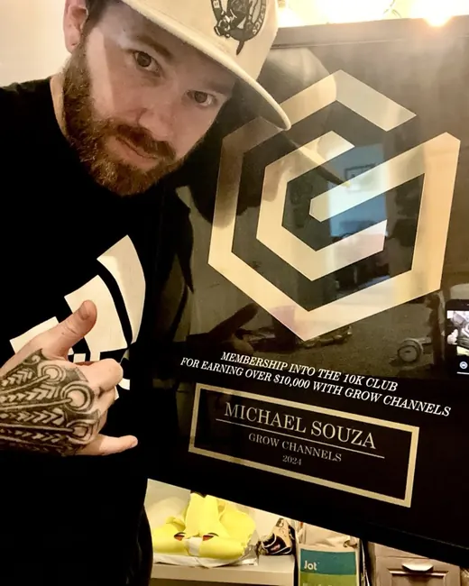 Michael Souza holding their 10K Club plaque