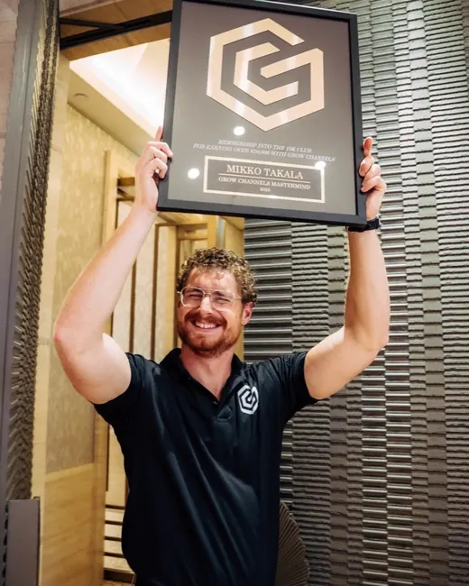 Mikko Takala holding their 10K Club plaque