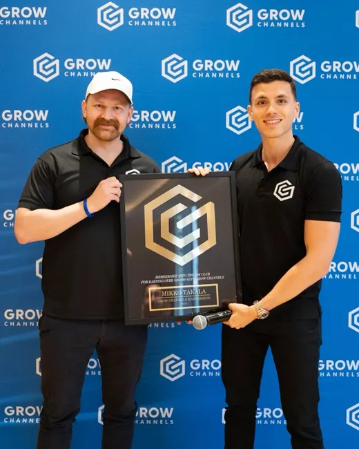 Mikko Takala holding their 10K Club plaque